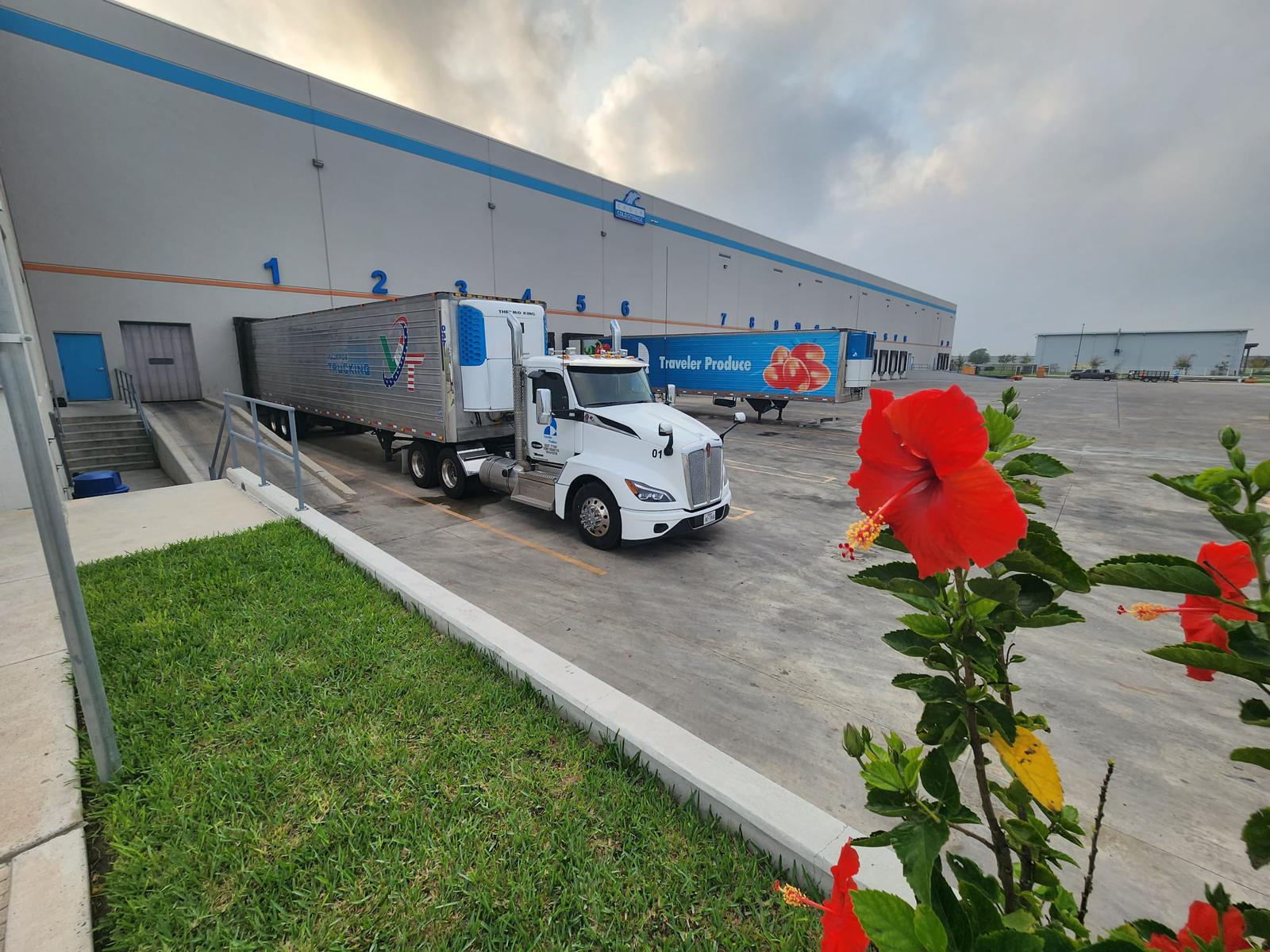 Refrigerated truck parked beside the warehouse loading docks